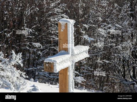 Wooden cross covered with snow Stock Photo - Alamy