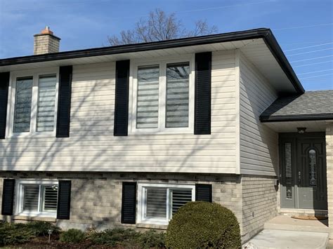 White Vinyl Siding With Black Shutters - Replacement windows and doors in St.Catharines and Niagara