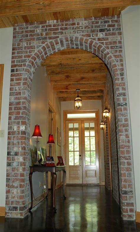 archway made of different material than walls to break up the space and make it look less long ...