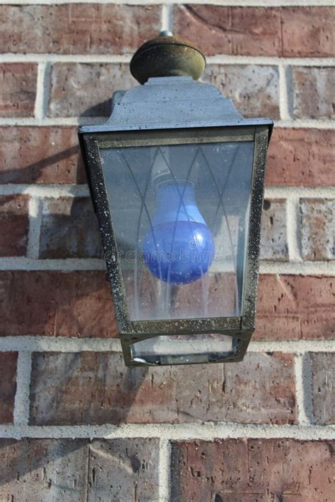 An Outdoor Light Fixture with a Blue Light Bulb Stock Photo - Image of light, blue: 109510094