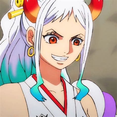 an anime character with white hair and horns on her head is smiling at the camera