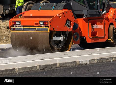 Road roller machine working on asphalt road maintenance project ...