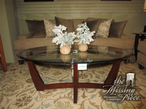 Rooms to Go oval glass top coffee table on a dark base with silver trim. Cool, contemporary ...