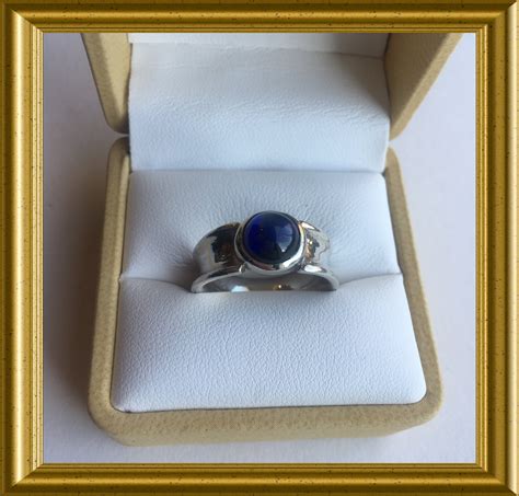 Silver ring with blue cabochon sapphire stone