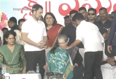 Revanth Reddy, wife touch Sonia's feet after being sworn in as CM ...