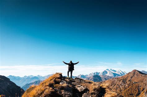 Man Standing on Top of The Mountain Free Stock Photo | picjumbo