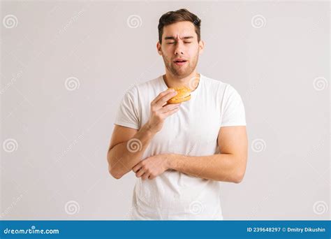 Portrait of Young Man Eating Bad Burger and Suffering Stomach Ache, Feeling Nausea, Food ...