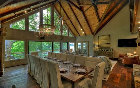 a large dining room with wooden floors and vaulted ceiling