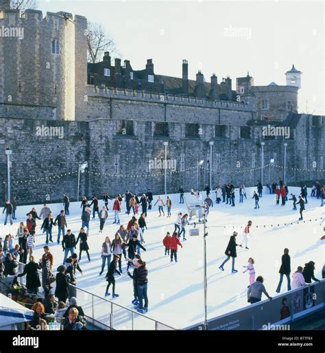 Ice skating at the outdoor Tower of London ice rink near Tower Bridge London UK KATHY DEWITT ...