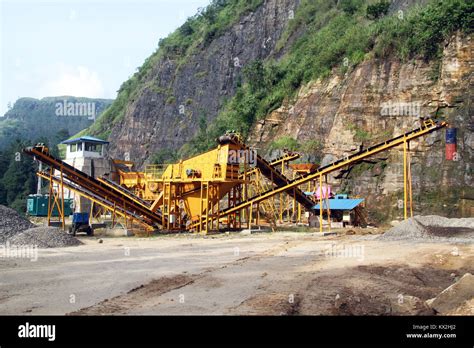 Yellow gravel conveyor near high mount Stock Photo - Alamy