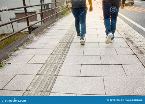 Two People Walking on a Sidewalk in the Morning Stock Photo - Image of women, traveling: 139048374