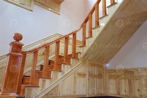 Beautiful wooden stairs. Golden stair made of wood, safety protection wooden stairs architecture ...