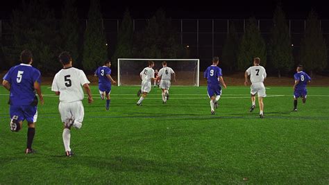 The Camera Follows A Soccer Player Down The Field As He Makes A Goal ...