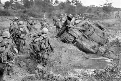 Marines move past an abandoned M60 Patton tank during the Vietnam War : r/DestroyedTanks
