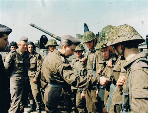 East German NVA Genossen under inspection. Of particular note is the wear of the helmet nets ...