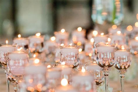 Tall votives with floating candles and low votives with floating candles will surround all the ...