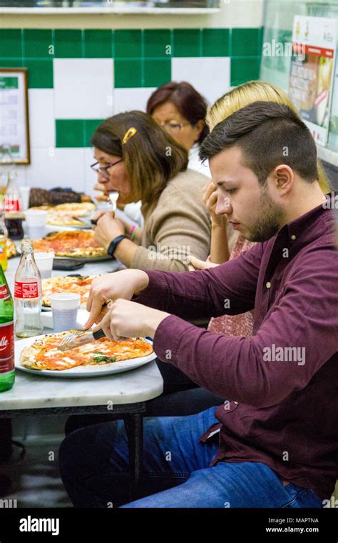 People eating pizza at the famous restaurant L'Antica Pizzeria Da Michele in Naples, Italy Stock ...