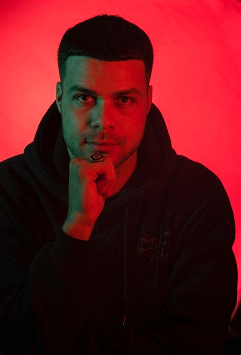 Man Wearing His Purple Hoodie on Purple Background · Free Stock Photo