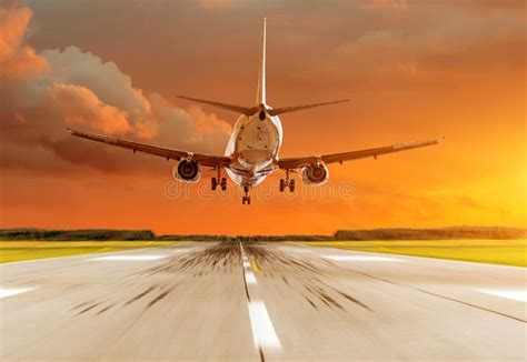 Passenger Airplane Landing at Sunset on a Runway. Stock Image - Image of departure, speed: 108501749