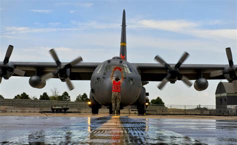 LAMINATED POSTER A C-130 Hercules aircraft equipped with a modular firefighting system prepares ...