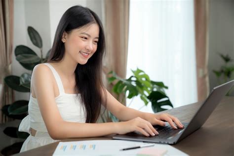 Premium Photo | Asian girl typing data to her computer notebook for prepare her report