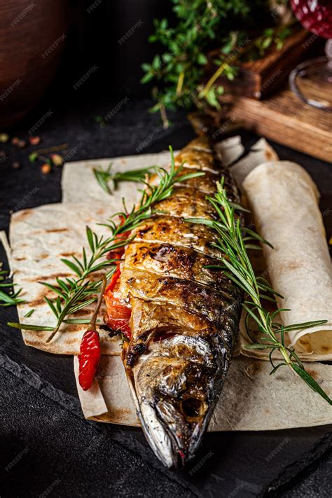 Premium Photo | Grilled mackerel fish with vegetables and rosemary