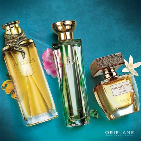 three different perfume bottles on a blue surface
