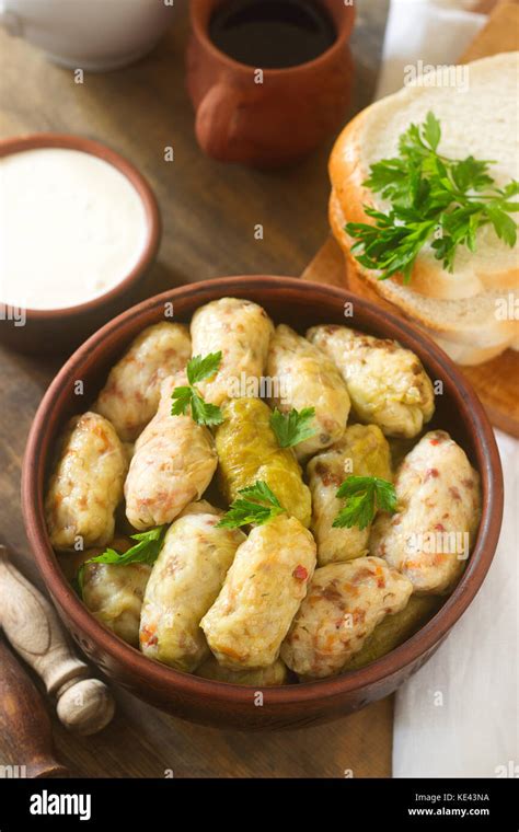 Cabbage rolls served with sour cream, bread and wine. Traditional ...