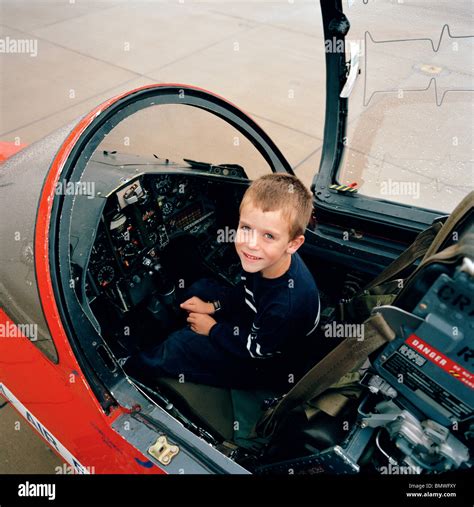 A young boy sits in BAE Systems Hawk cockpit of the 'Red Arrows', Britain's Royal Air Force ...