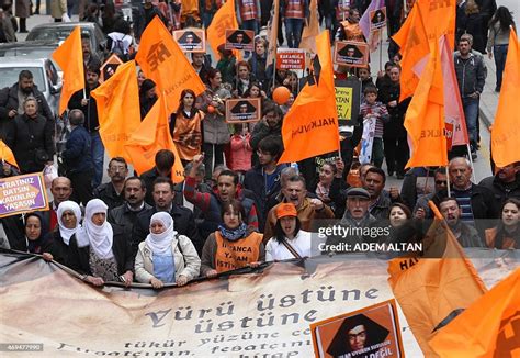 People hold flags and signs during a protest against Turkey's ruling ...