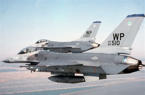 A left side view of two F-16 Fighting Falcon aircraft flying in formation during exercise Team ...