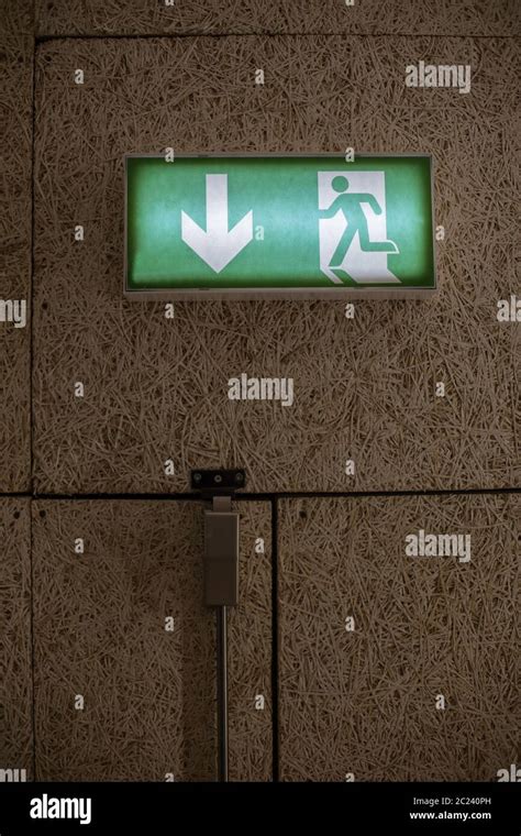 Color image of a green exit sign above a door Stock Photo - Alamy