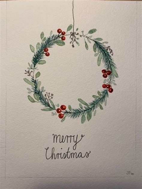 a watercolor christmas card with a wreath and berries on the front that says merry christmas