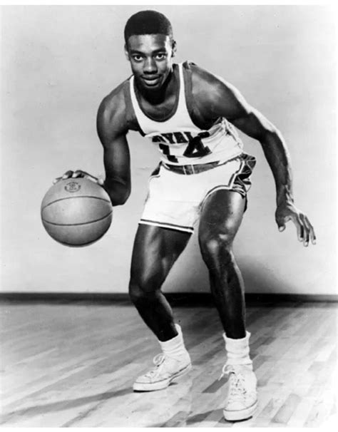 a black and white photo of a man holding a basketball