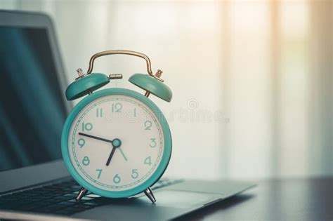 An alarm clock on laptop stock photo. Image of deadline - 275944996