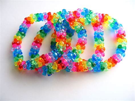 multicolored bracelets are arranged on a white surface