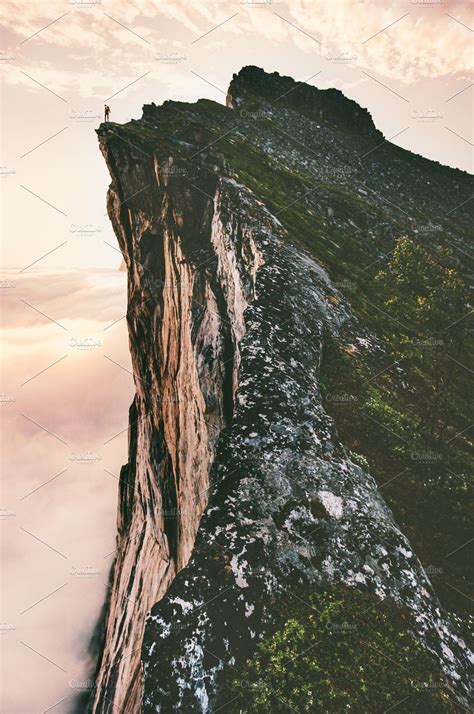 Man standing on cliff edge mountain | Cliffs tattoo, Mountain drawing ...