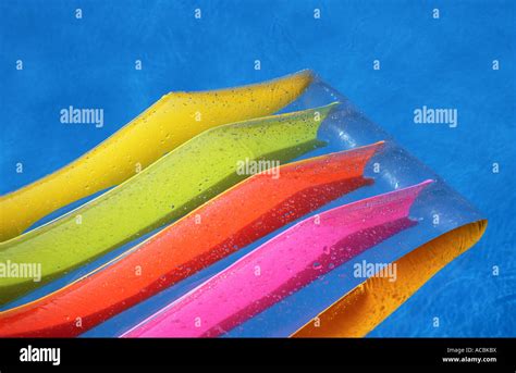 Colourful lilo in swimming pool Stock Photo - Alamy