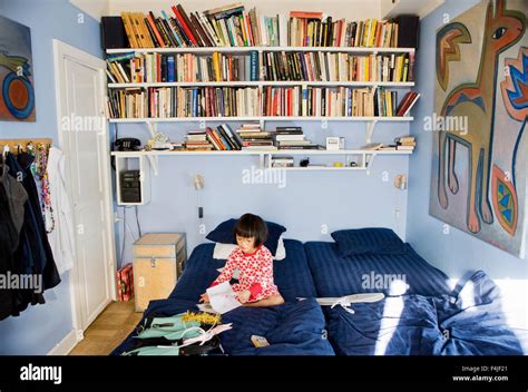 Girl reading book on bed Stock Photo - Alamy