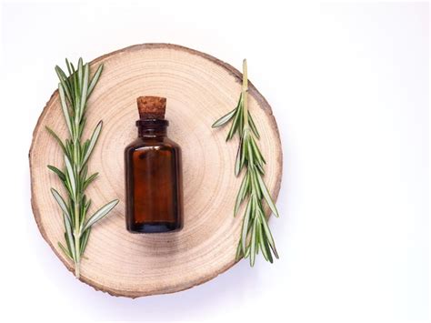 Premium Photo | Rosemary essential oil and fresh branches of plants