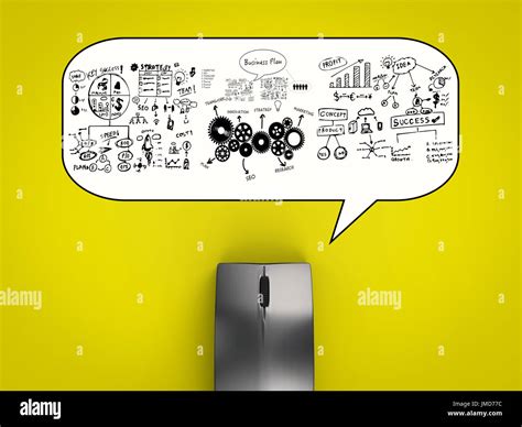 black wireless mouse with business plan on yellow background Stock Photo - Alamy