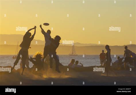 USA, Seattle, Washington, Golden Gardens Park. People playing frisbee ...