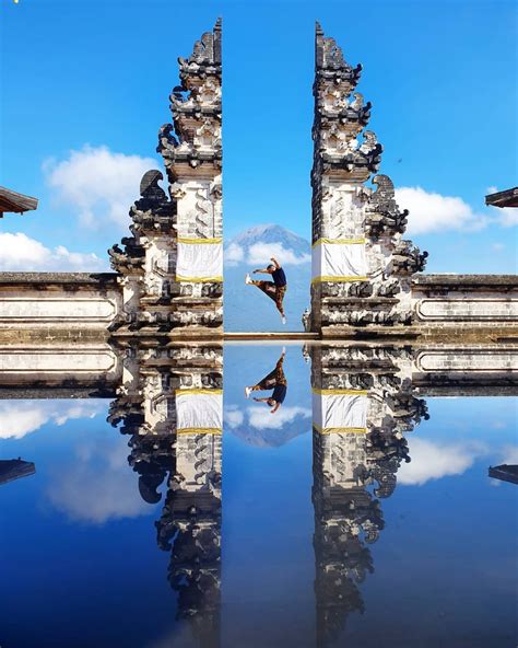 The Gates of Heaven in Bali, a popular spot for tourists, is not on the edge of a calm lake at ...