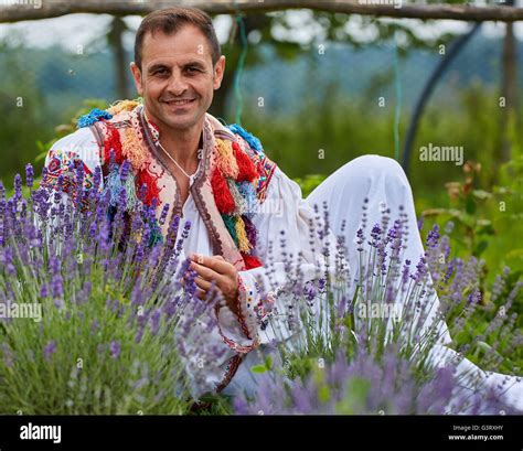 Romanian farmer in traditional costume near his lavender field Stock ...