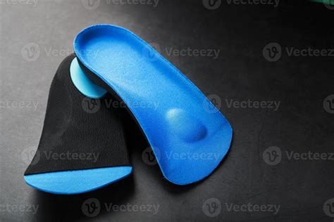 Orthopedic insoles for correction of pronation of the foot on a dark ...