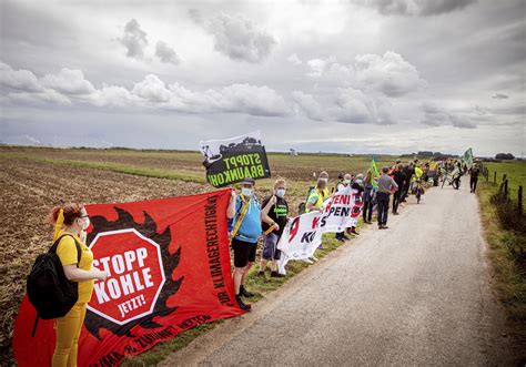 Activists form human chain demanding exit from coal mining | AP News