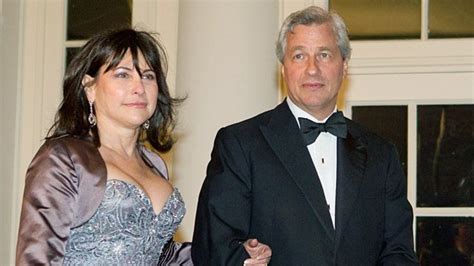 a man in a tuxedo standing next to a woman wearing a dress and tie