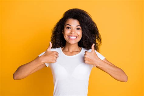 woman with thumbs up and yellow background - Wyoming Department of Health