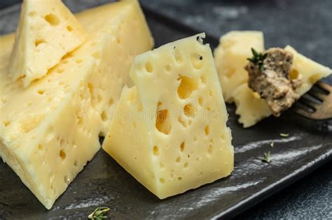 Cheese with Holes and Mushrooms Sauce, Truffle Paste on a Black Plate. Banner, Menu, Recipe ...