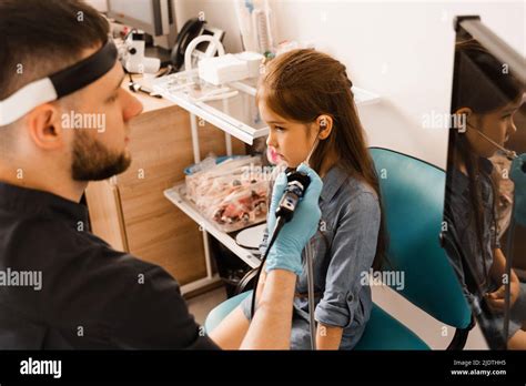 Ears endoscopy of child. Otoscopy procedure with otoscope. ENT doctor ...